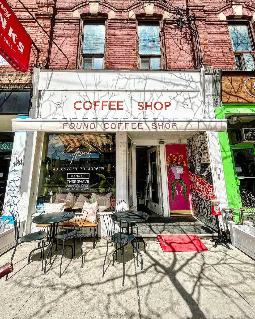 Found Coffee on College | Exterior of Found Coffee in Little Italy with a white facade and outdoor seating | Homes Almanac
