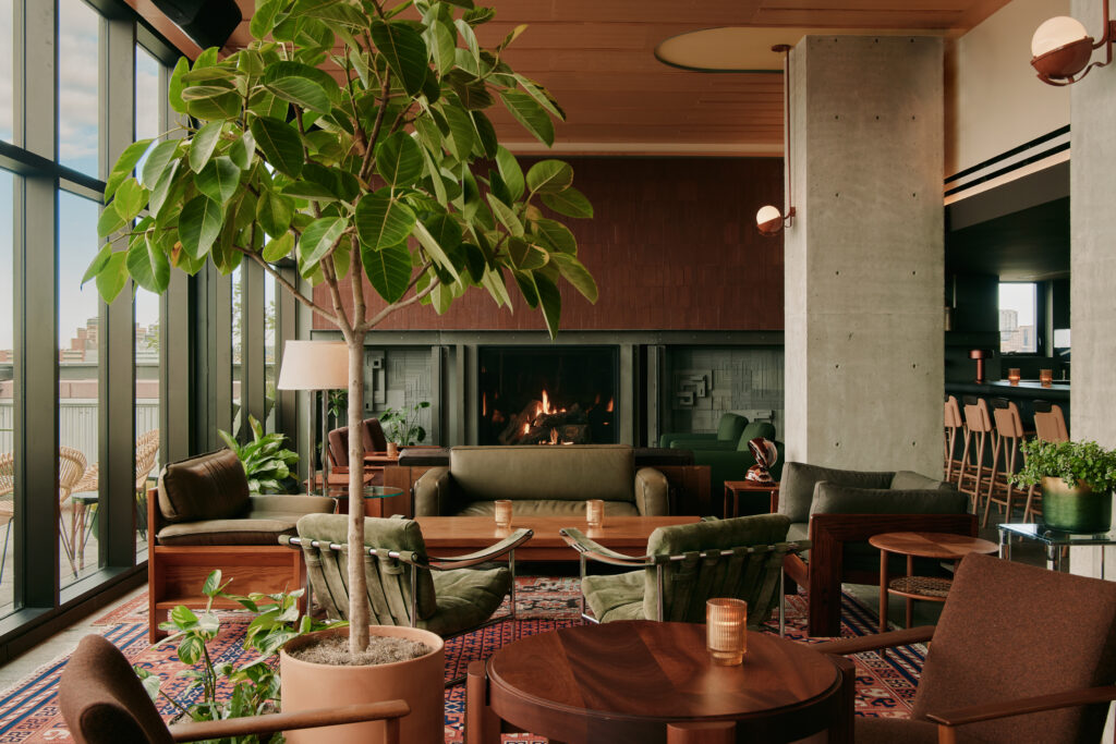Ace Hotel Toronto | Evangeline rooftop bar at Ace Hotel, featuring modern seating, warm lighting, and city skyline views at dusk | Homes Almanac