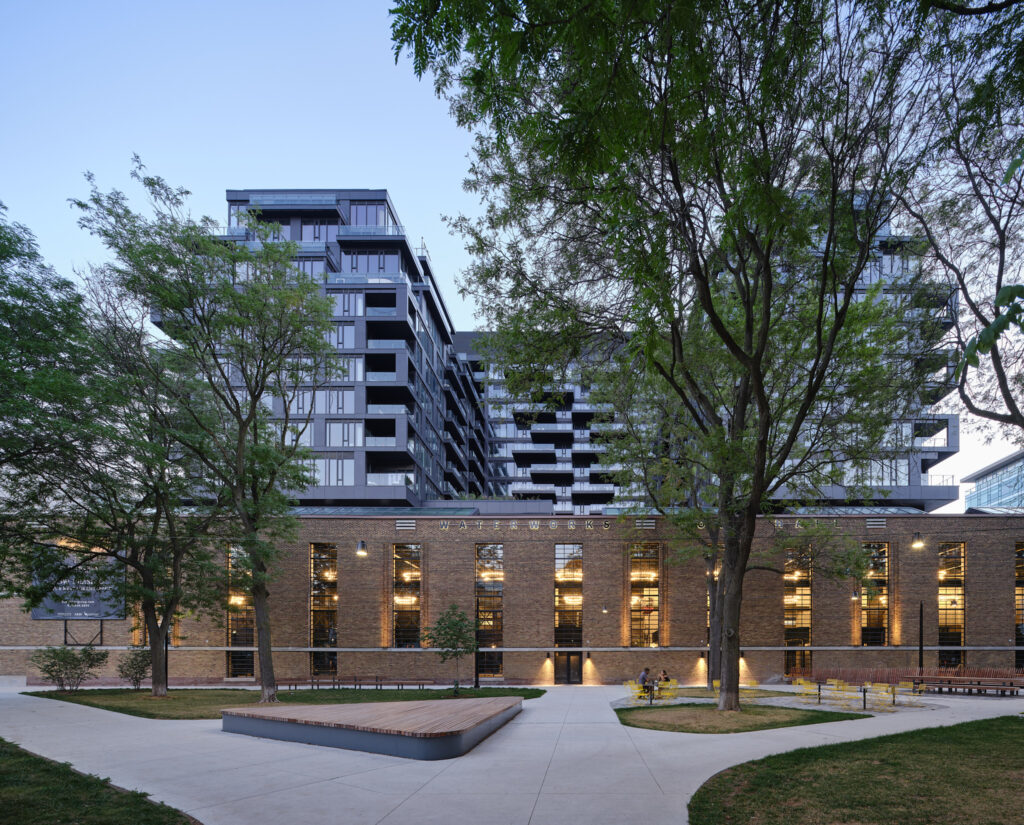 Waterworks Food Hall | Exterior of Waterworks Food Hall in the evening nestled between trees of St. Andrew's Park | Homes Almanac