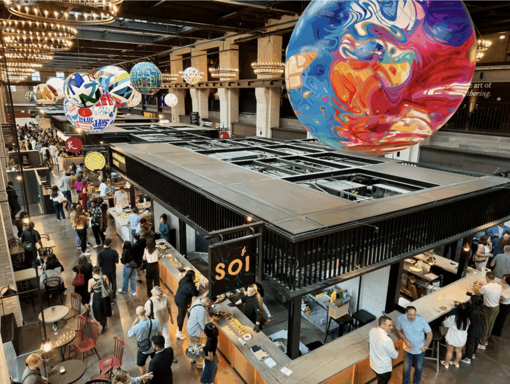 Waterworks Food Hall | Aerial shot of the Waterworks Food Hall bustling with people socializing, eating, and drinking | Homes Almanac
