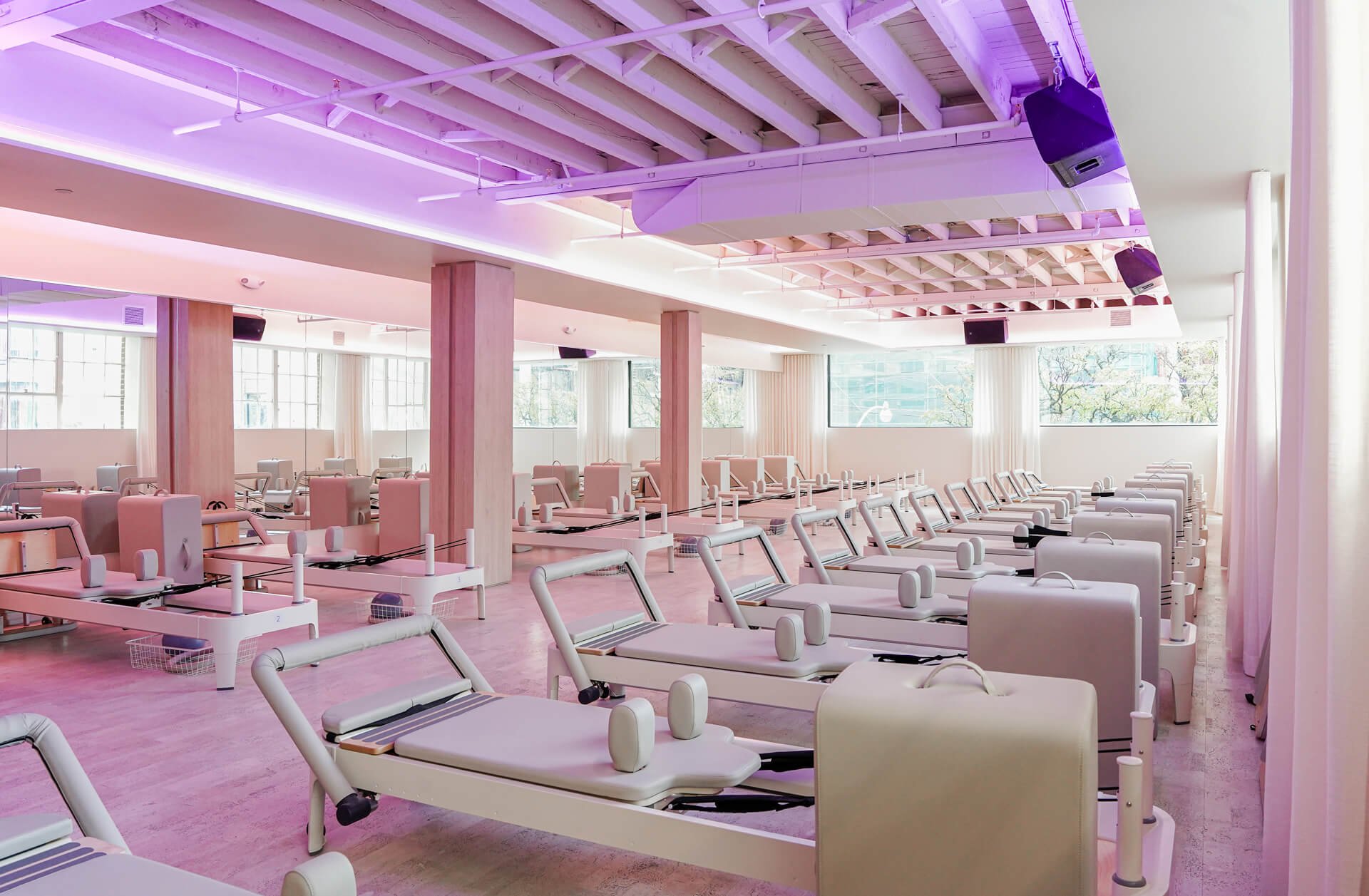 Solis Movement King West | Reformer room with purple tinted lighting | Homes Almanac