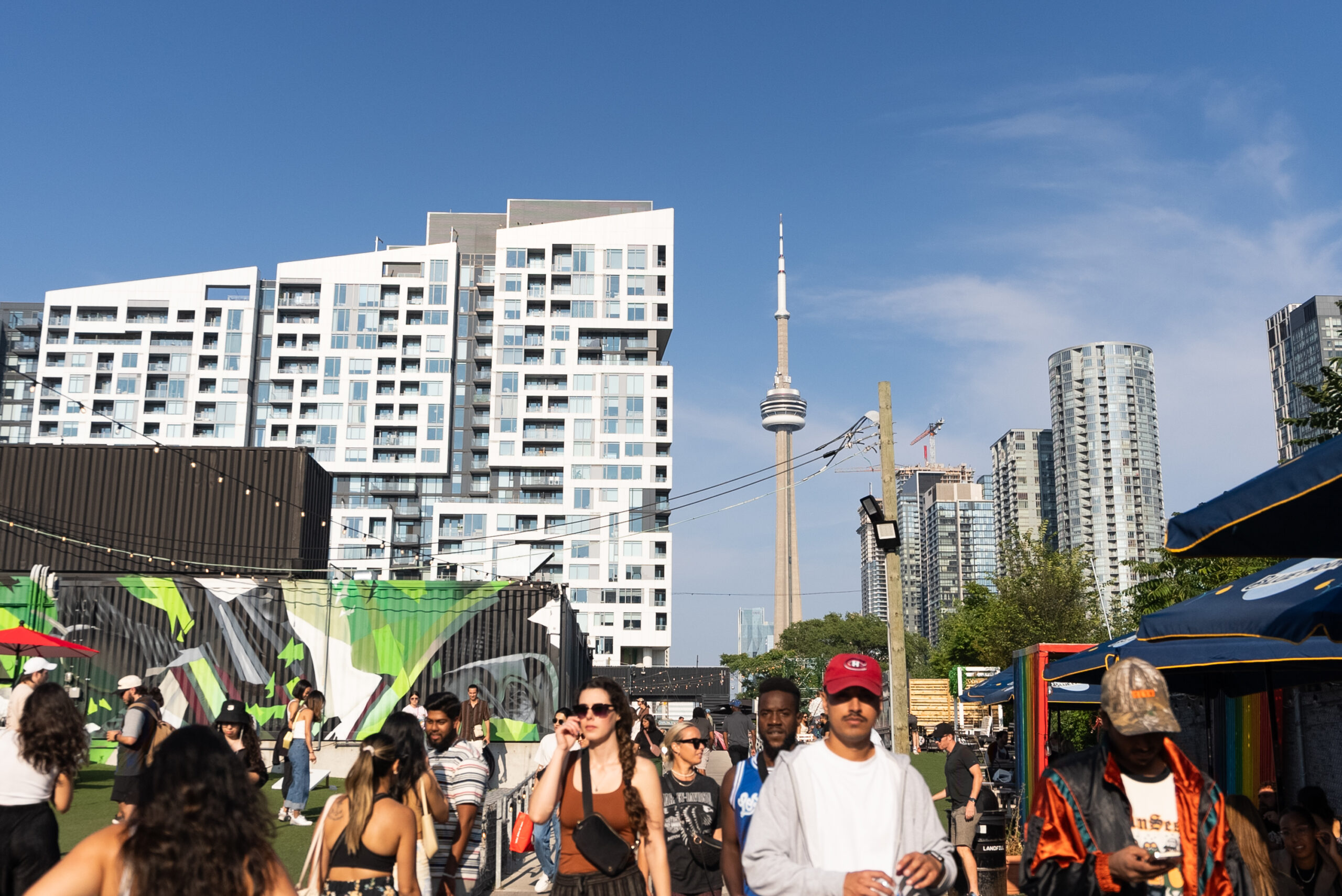 Stackt Market Toronto | People visiting Stackt Market with skyline view of the CN Tower | Homes Almanac