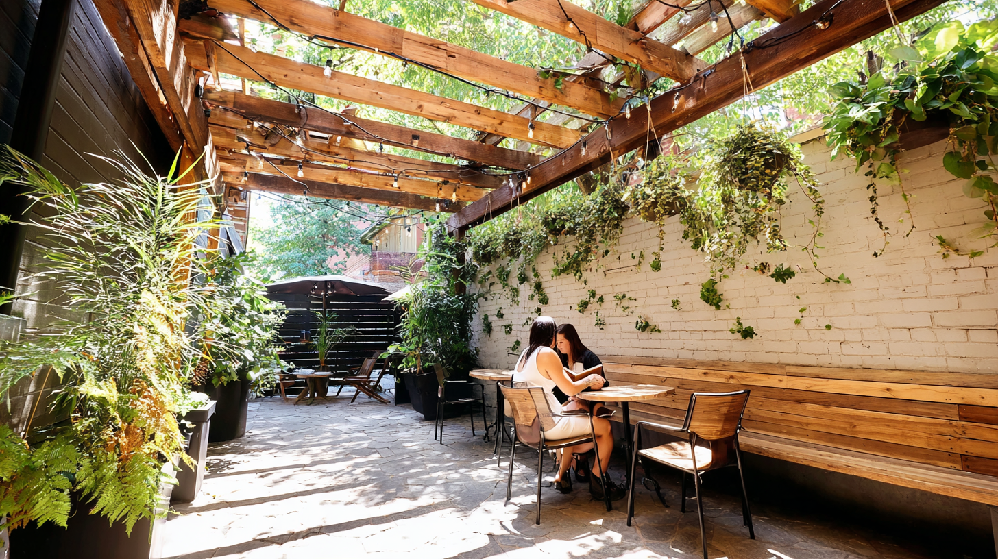 Third Places | Outdoor coffee shop patio with leafy greenery and wooden seating | Homes Almanac