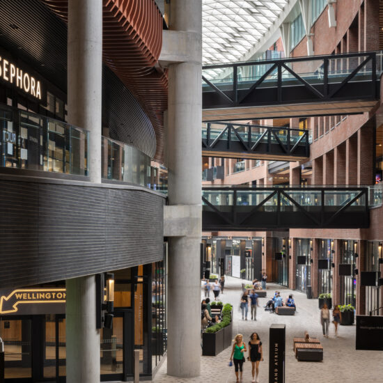 The Well Toronto | Inside the open air multi-use development showcasing 3 levels and people browsing shops | Homes Almanac