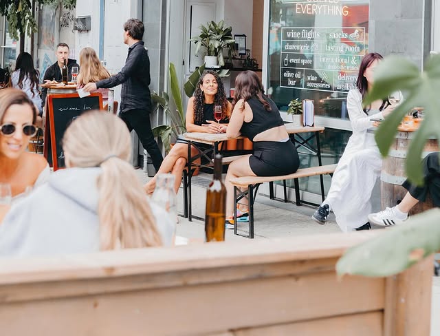 Ossington Wine Crawl | Downtown Winery's patio with people chatting drinking wine | Homes Almanac