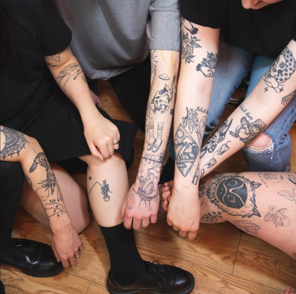 Bebop Ink Vancouver | Overhead shot of arms with black ink tattoos | Homes Almanac