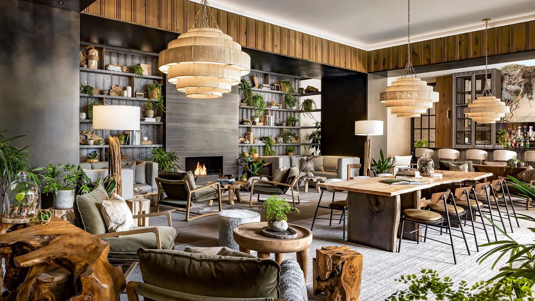 Flora Lounge | Bright lounge with leafy green plants and cozy low slung seating with wood and earthy decor | Homes Almanac