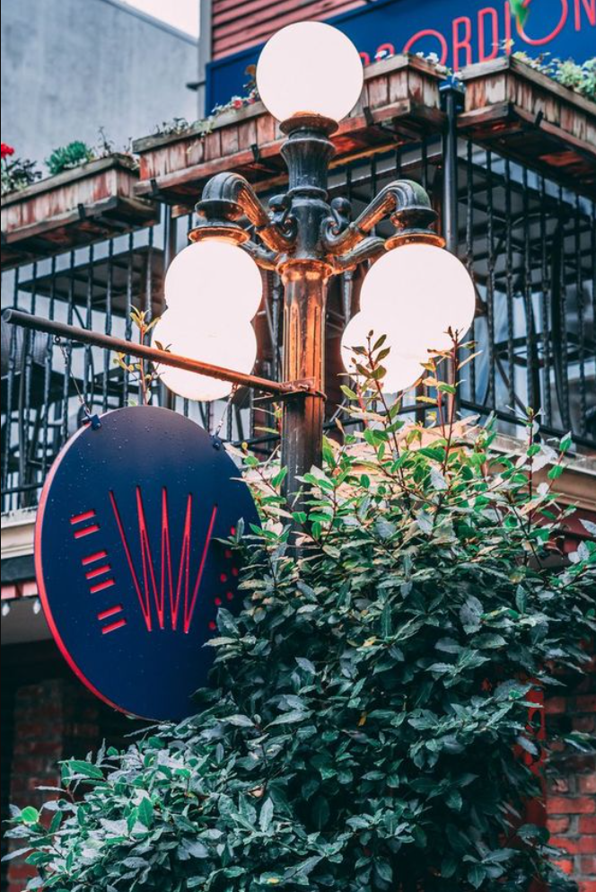 The Red Accordion Vancouver | Vintage street lighting with The Red Accordion sign | Homes Almanac