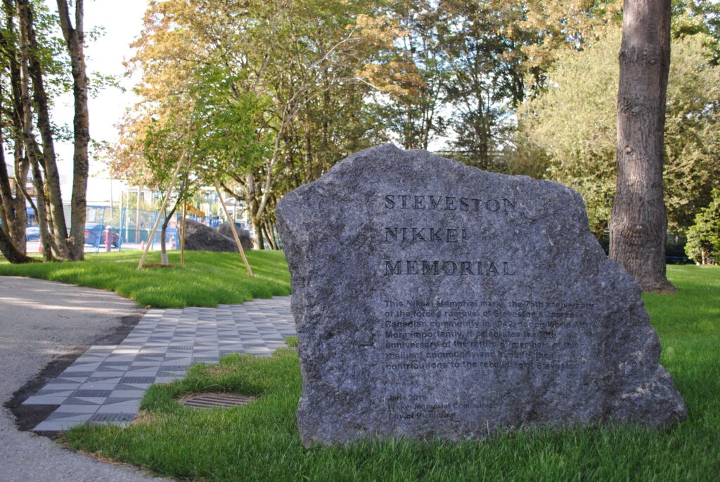 Steveston Japanese Canadian history | A grey rock representing the Steveston Nikkei Memorial with grassy park in the background | Homes Almanac
