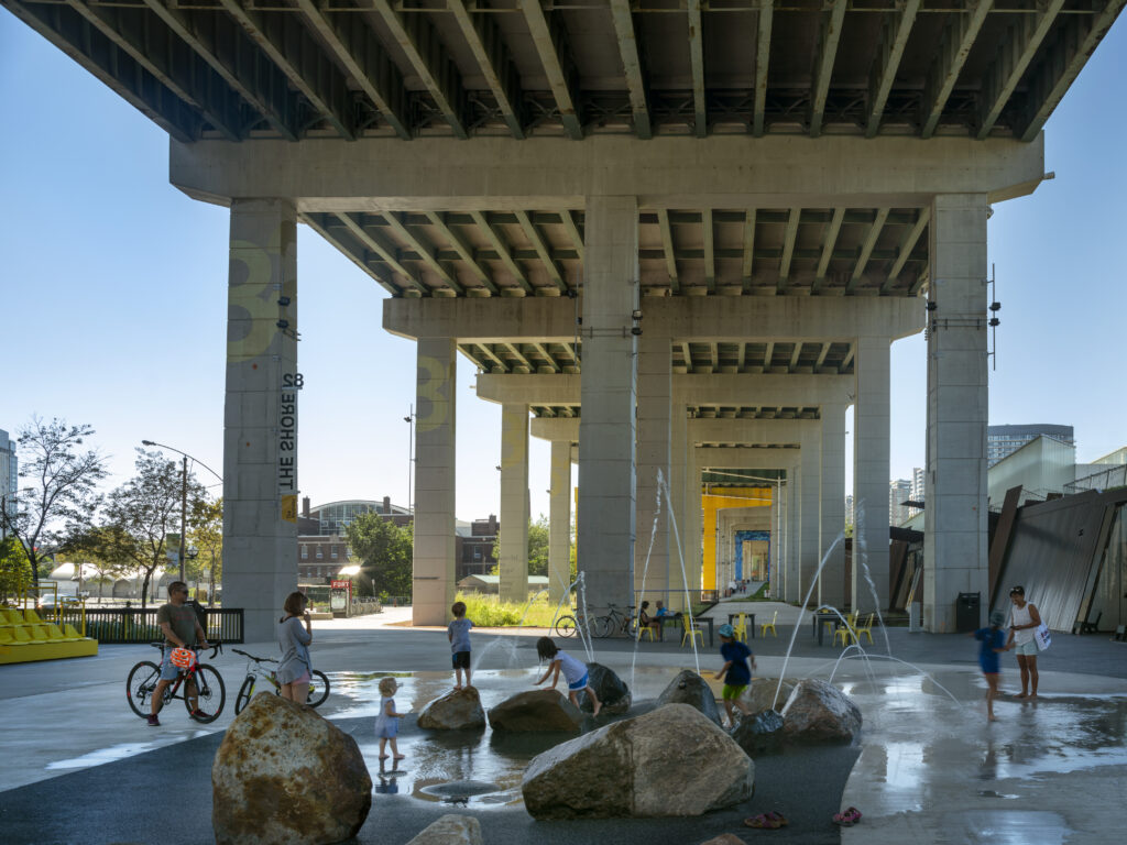 Canoe Landing | Kids play in the water installment under The Bentway on a sunny day | Homes Almanac