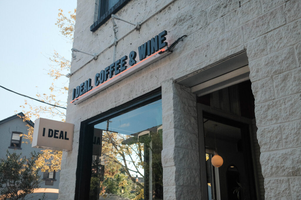 i deal coffee & wine on ossington | Exterior of coffee shop with white brick facade | Homes Almanac