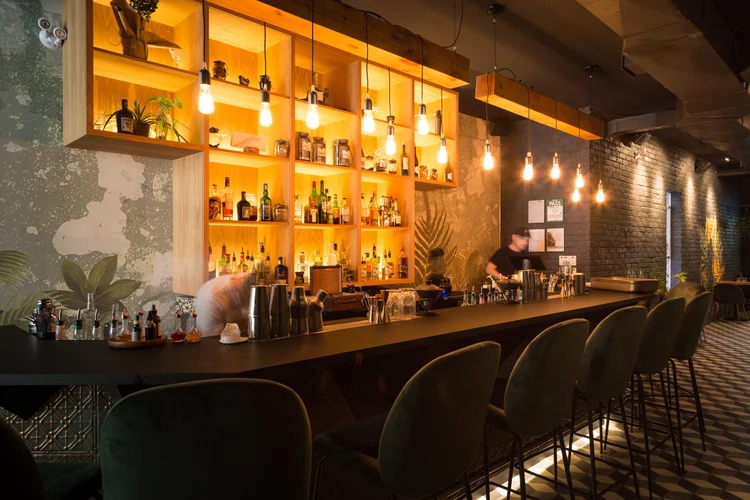 fermentation cocktails toronto | softly lit bar with green velvet chairs | Homes Almanac