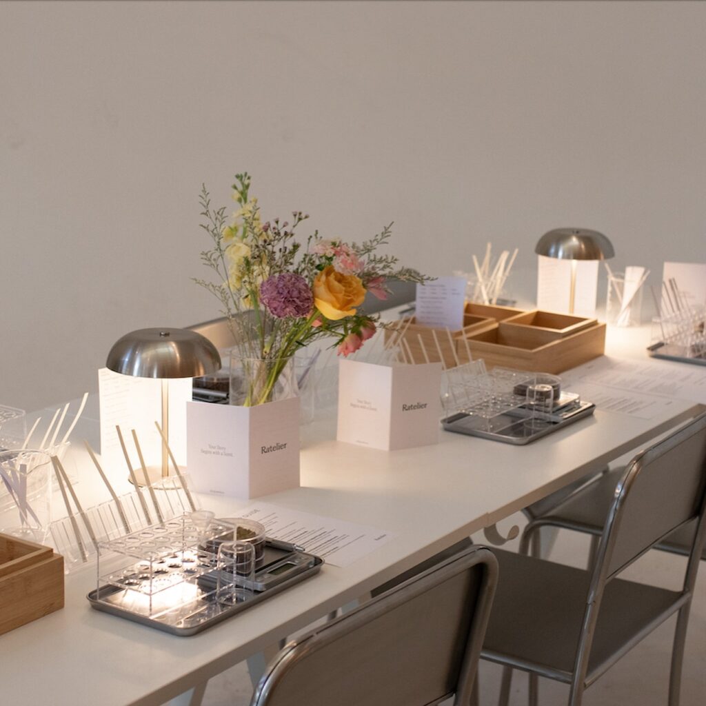 Ratelier Trinity Bellwoods | White table with a vase of flowers and perfumery workshop set up | Homes Almanac