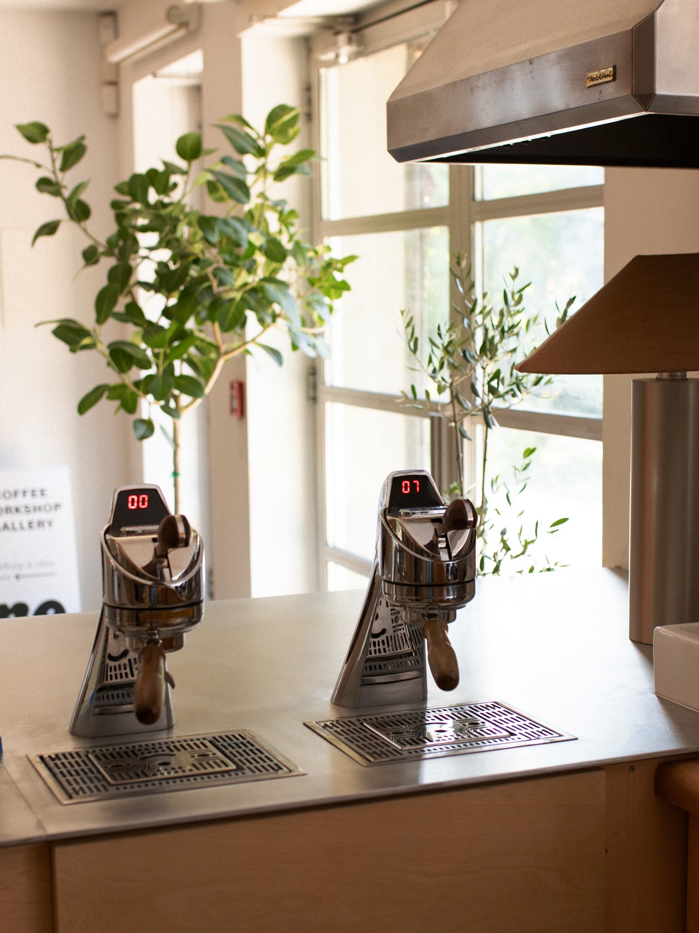 Ratelier Trinity Bellwoods | Soft daylight hits the interior of the coffee bar with high end espresso machines | Homes Almanac