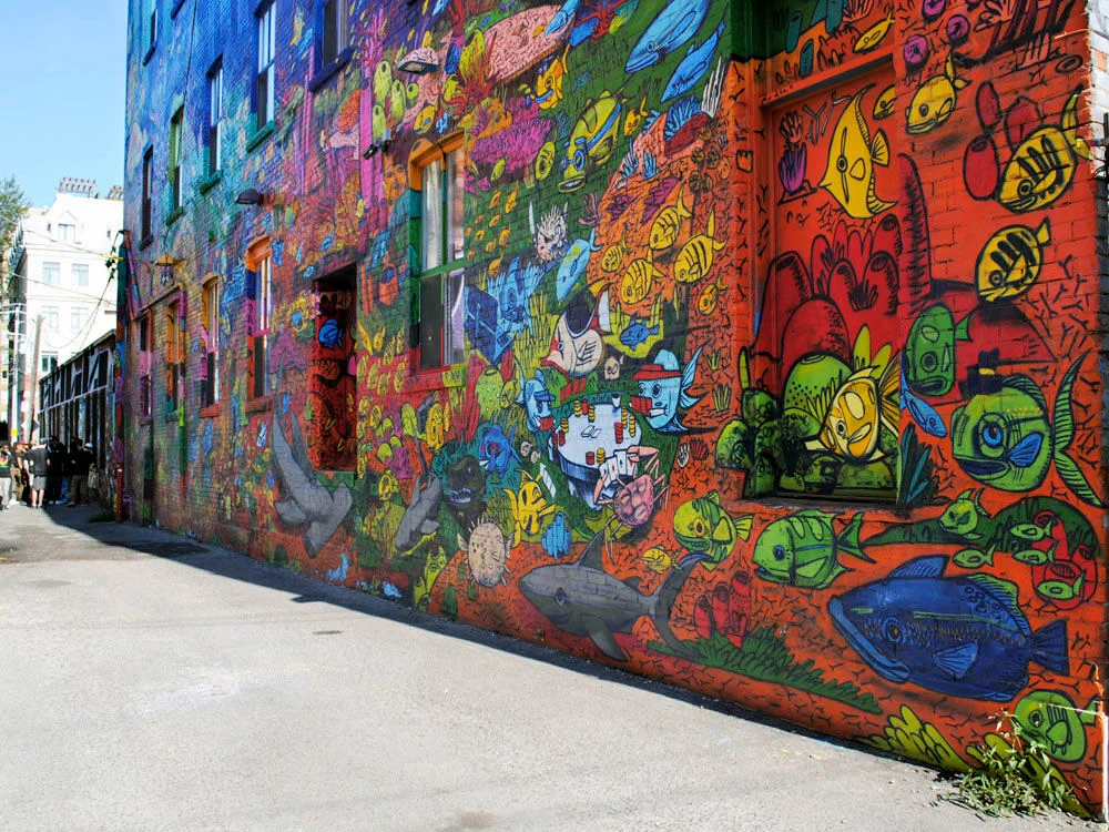 Brightly painted alleyway wall of street art | graffiti alley | Homes Almanac