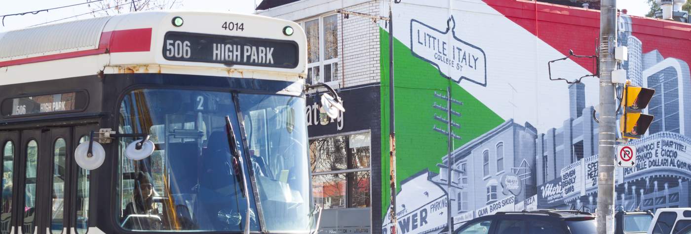 Coffee Shops on College in Toronto's Little Italy | A bus driving by a colourful mural of Little Italy | Homes Almanac