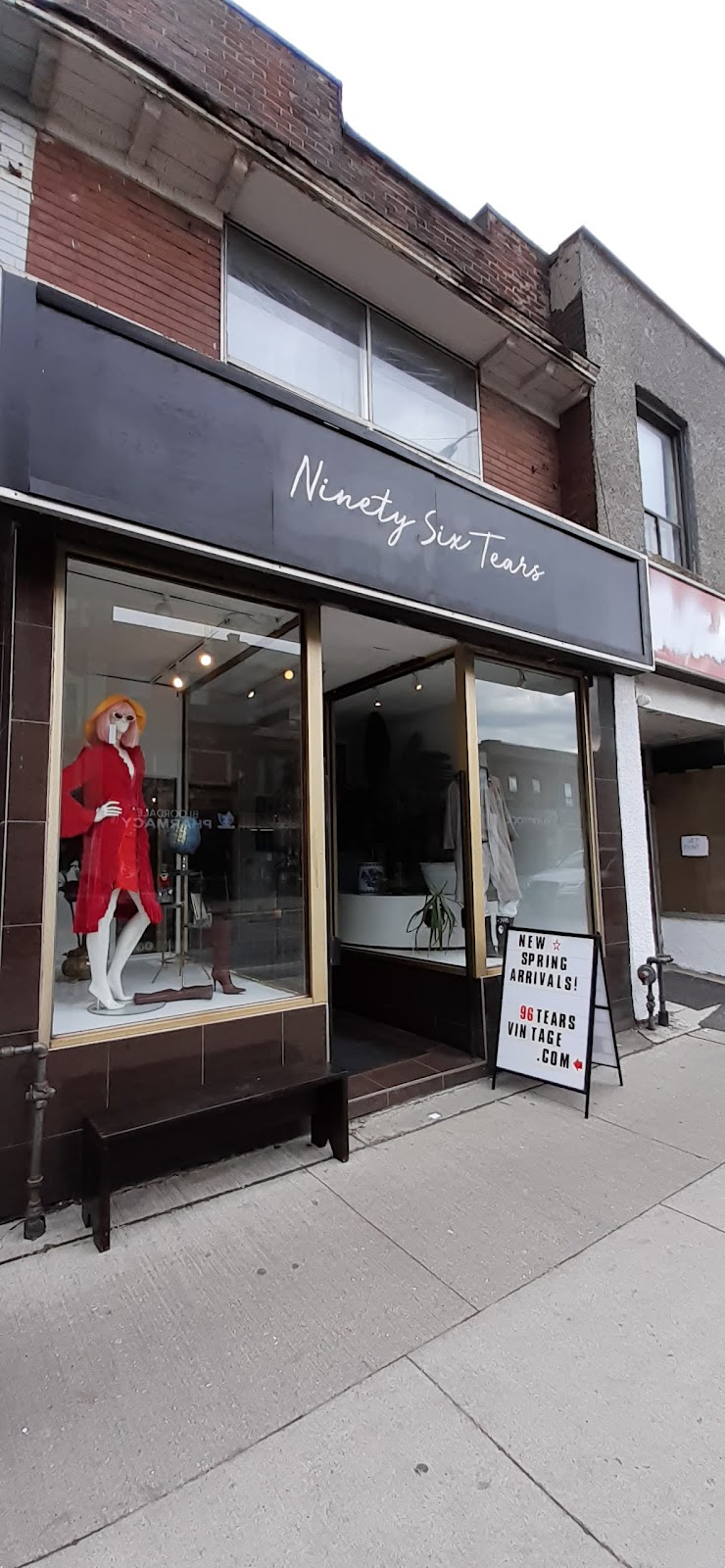 96 Tears Vintage | Exterior shot of shop with a mannequin dressed in a red dress in the window and white sandwich board outside by the entrance | Homes Almanac