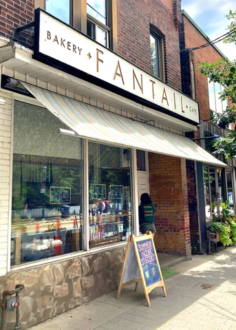 Fantail | Exterior of a bakery and coffee shop with a white awning and white sign | Homes Almanac