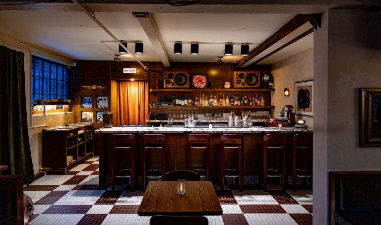 The wooden bar with moody lighting at Osteria Otto | Osteria Otto Mount Pleasant | Homes Almanac