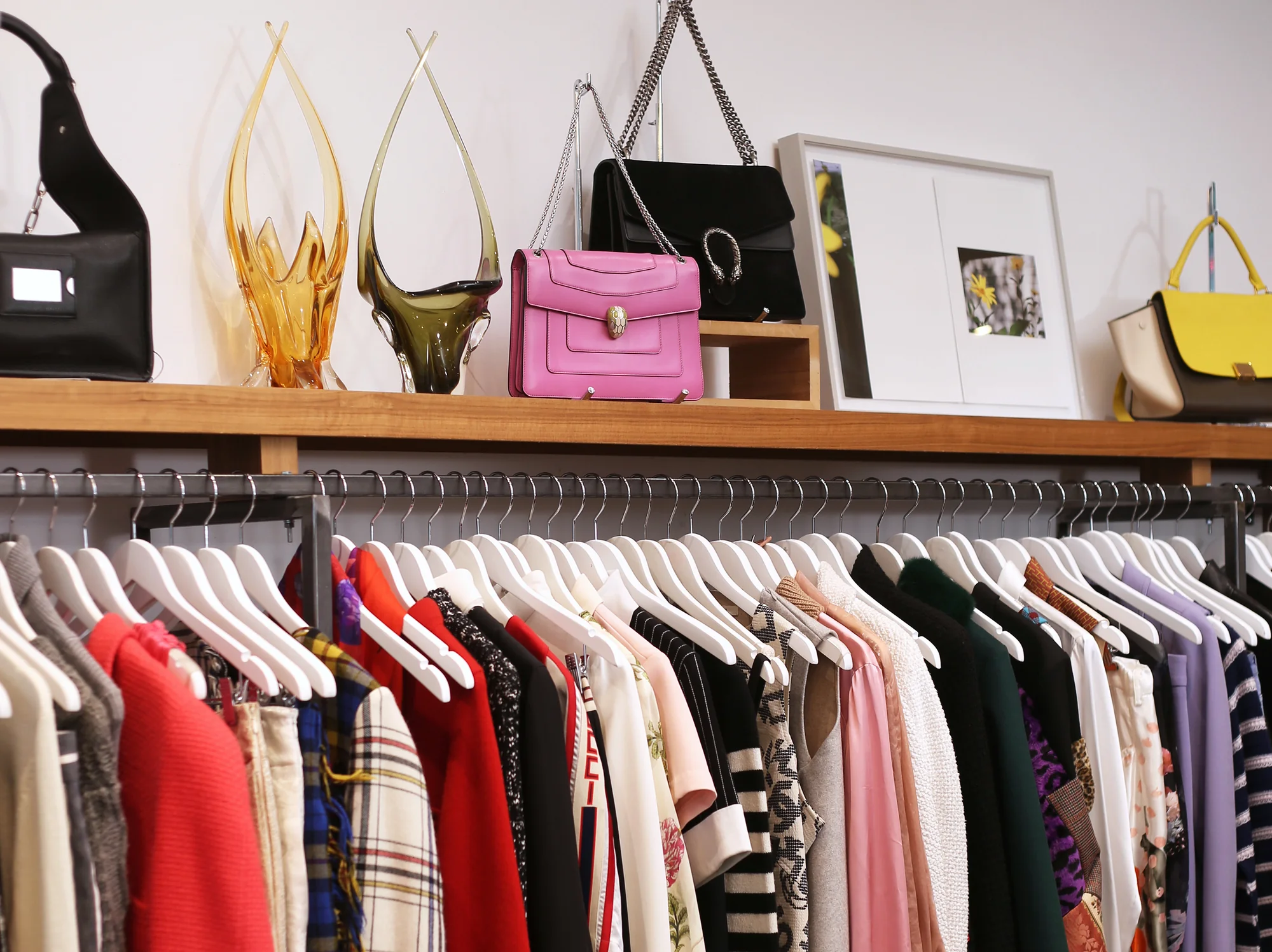 VSP Consignment | Rack and shelf with brightly coloured purses and tops | Homes Almanac